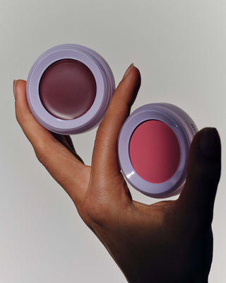 hand holding 2 lip and cheek stackable product layers