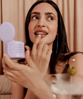 woman sitting in a restaurant using her subtl makeup stack