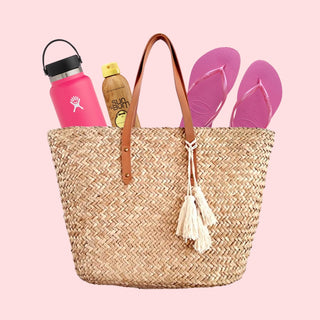 Imagine of bag with water bottle, suncreen and flip flops